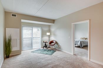 an empty living room with a door to a bedroom at Residences at the Street, Washington, Pennsylvania